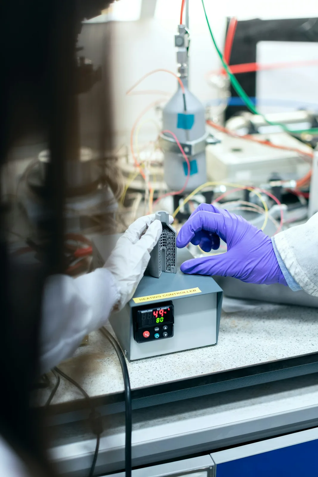 Close-up of technicians working on precision lab equipment