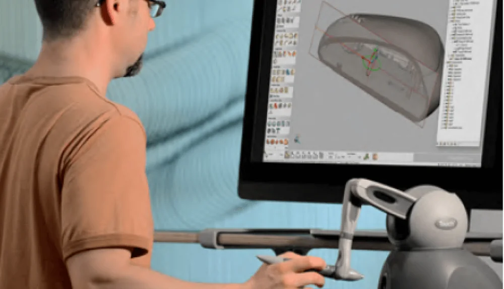 Designer using a haptic stylus device to sculpt in Geomagic Freeform